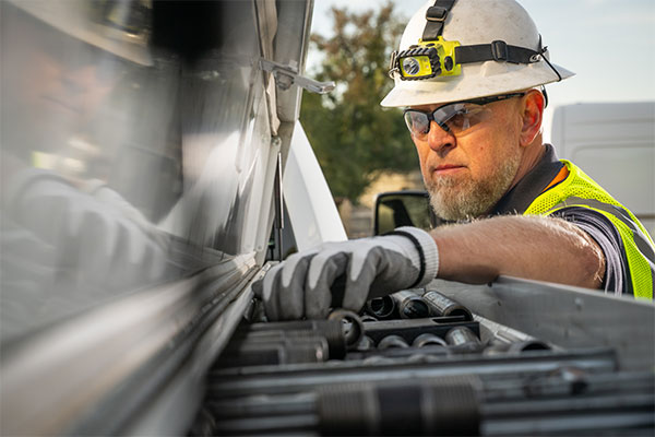 tech with tools in back of truck